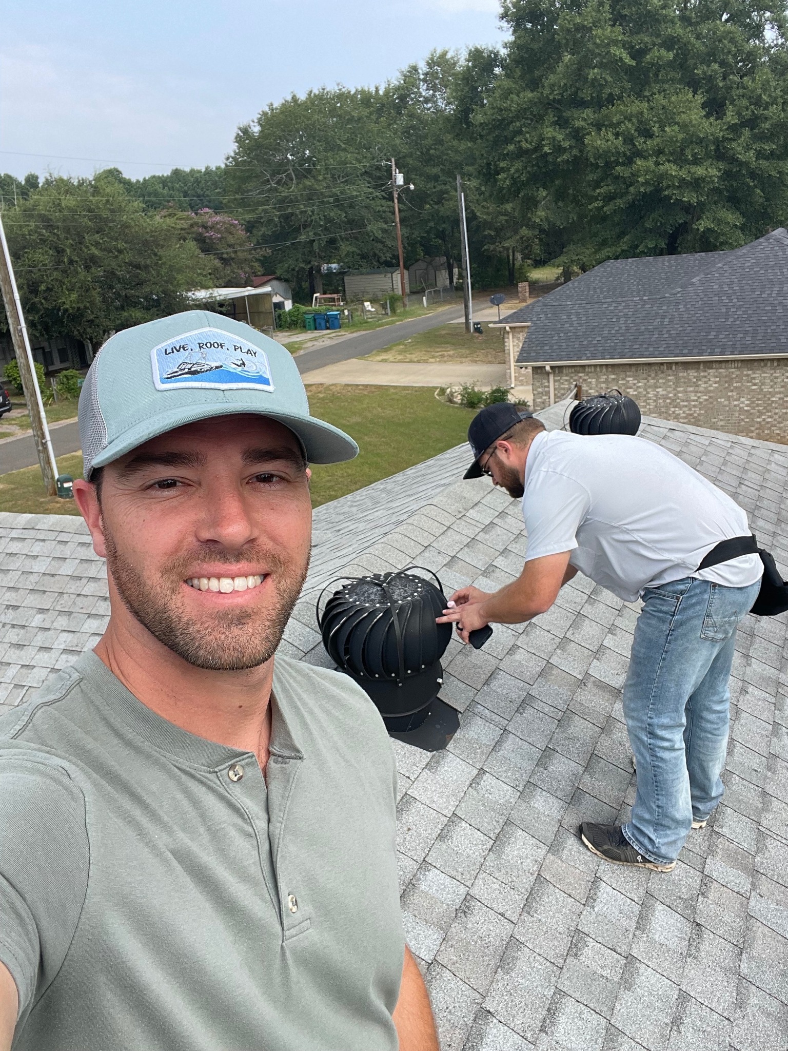 Elevation Roofing team with company sign